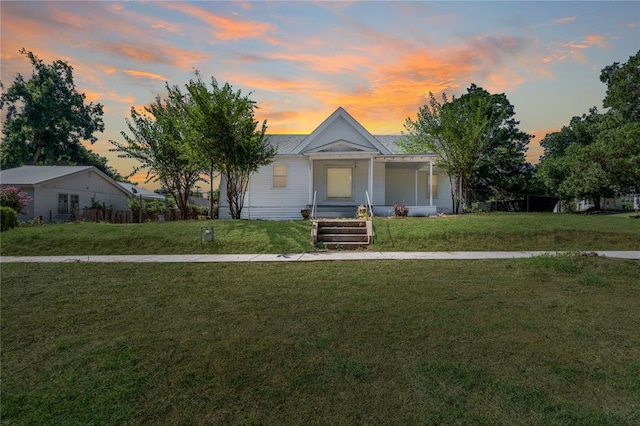 view of front facade with a yard and covered porch