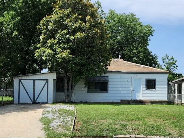 back of property with an outbuilding and a lawn