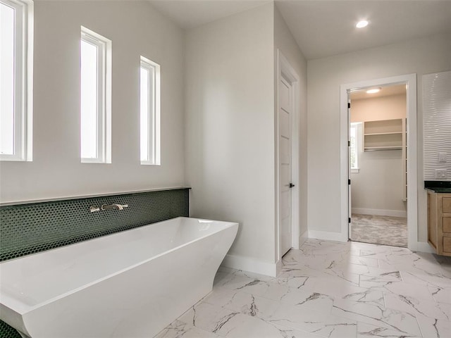 bathroom with vanity and a tub