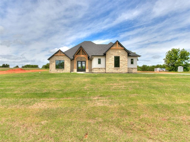 view of front of property featuring french doors and a front lawn