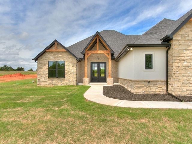 view of front of home featuring french doors and a front yard