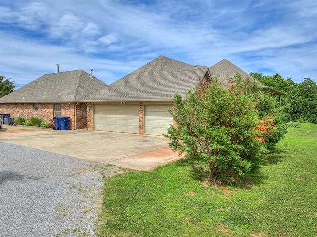 view of front of property with a garage and a front lawn