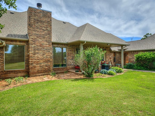 rear view of property with a lawn