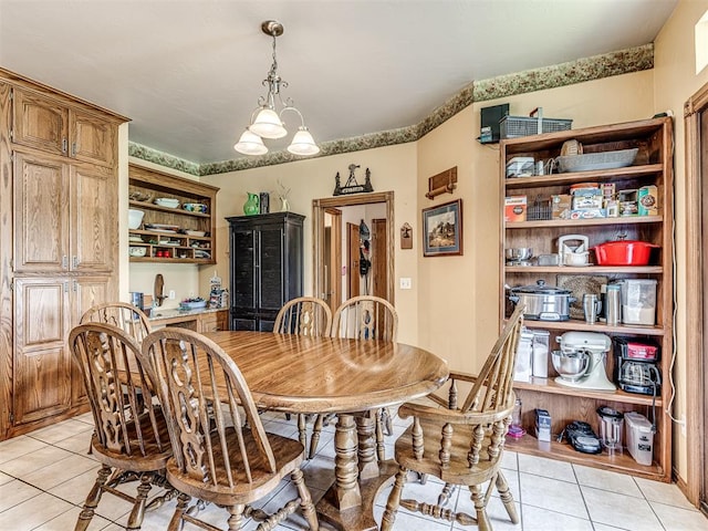 tiled dining space featuring a chandelier