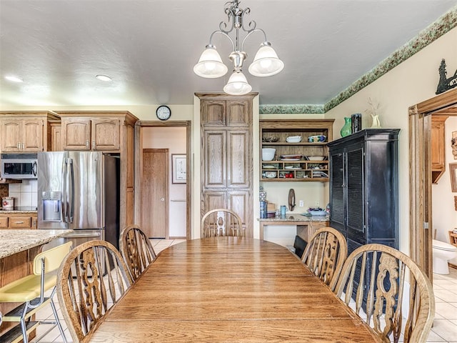 tiled dining space with an inviting chandelier