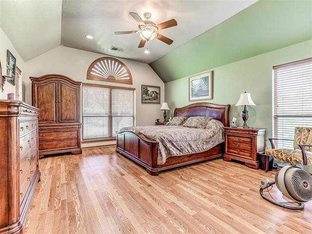 bedroom with ceiling fan, vaulted ceiling, and light hardwood / wood-style flooring