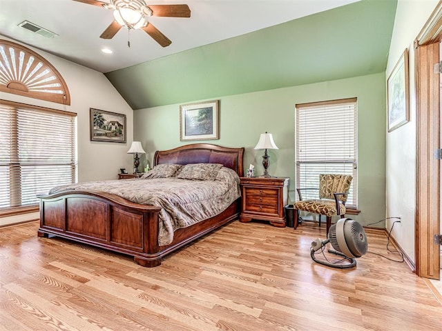 bedroom with ceiling fan, light hardwood / wood-style floors, and vaulted ceiling