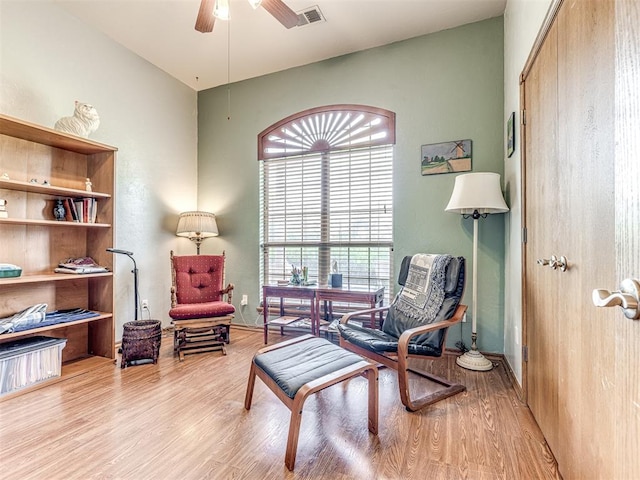 sitting room featuring light wood-type flooring and ceiling fan