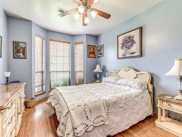 bedroom featuring light hardwood / wood-style flooring and ceiling fan