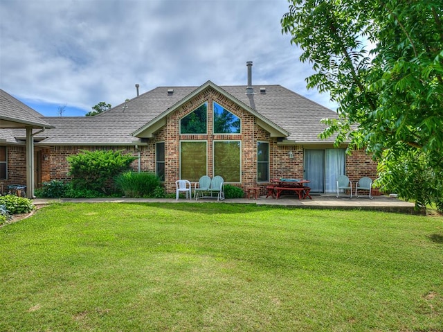 back of property featuring a patio area and a lawn