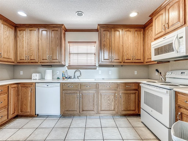 kitchen featuring white appliances, a textured ceiling, crown molding, sink, and light tile patterned floors