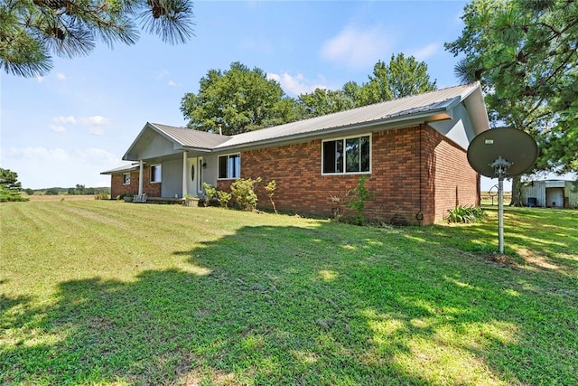 422502 E 1100th Rd, Checotah, OK 74426 - single story home featuring a front yard, brick siding, and a metal roof