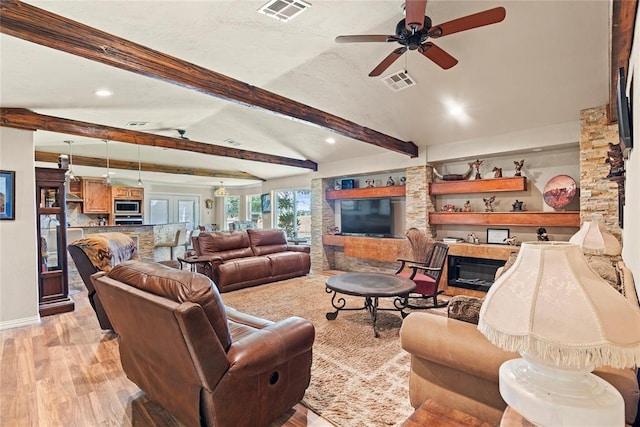 422502 E 1100th Rd, Checotah, OK 74426 - living area with light wood finished floors, beam ceiling, recessed lighting, a glass covered fireplace, and a ceiling fan