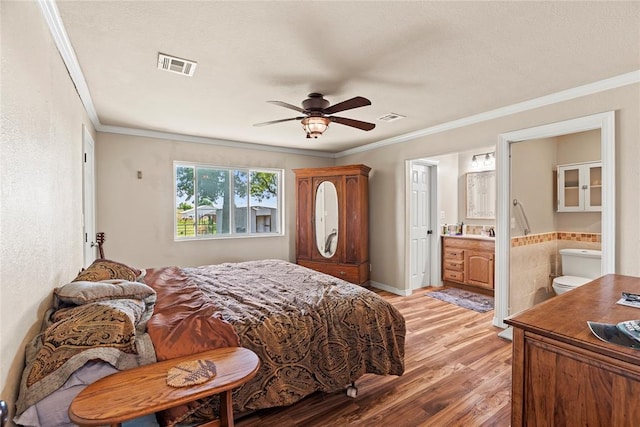 422502 E 1100th Rd, Checotah, OK 74426 - bedroom with crown molding, light wood-style floors, ensuite bath, and a ceiling fan