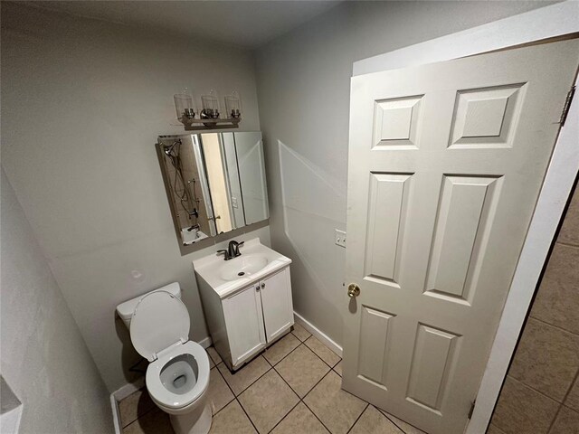 bathroom featuring toilet, vanity, and tile patterned floors