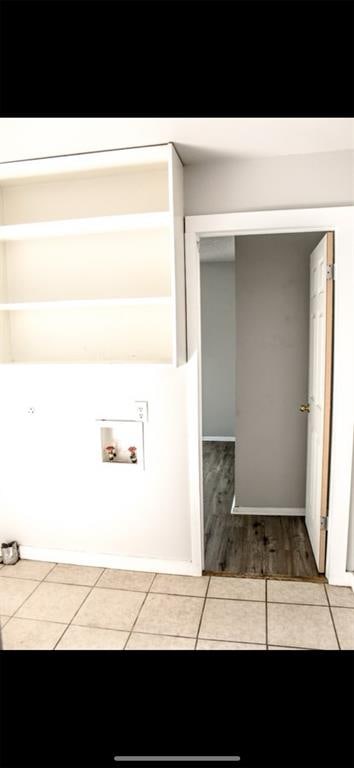 laundry room featuring hookup for a washing machine and light tile patterned flooring