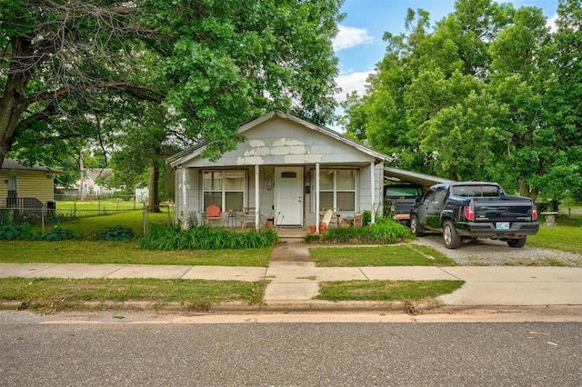 bungalow with covered porch and a carport