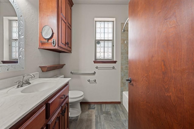 full bathroom featuring shower / bathing tub combination, toilet, vanity, and hardwood / wood-style flooring