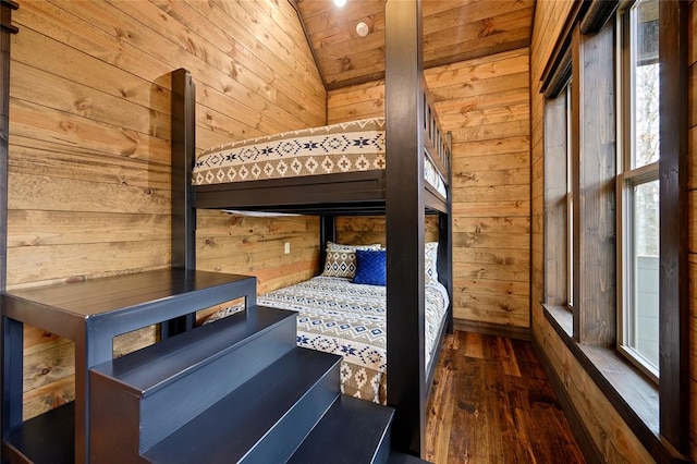 unfurnished bedroom featuring wood walls, dark hardwood / wood-style floors, vaulted ceiling, and wooden ceiling