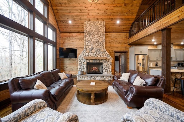 living room with a fireplace, high vaulted ceiling, plenty of natural light, and wood ceiling