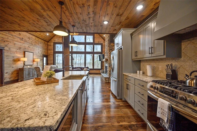 kitchen featuring appliances with stainless steel finishes, premium range hood, light stone counters, and wood ceiling