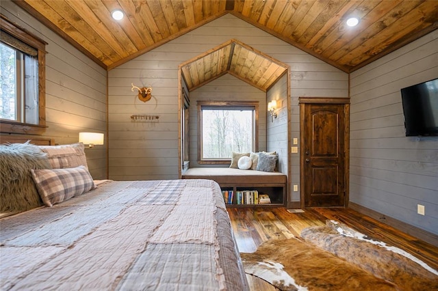 unfurnished bedroom featuring wooden ceiling, wood-type flooring, wooden walls, and vaulted ceiling