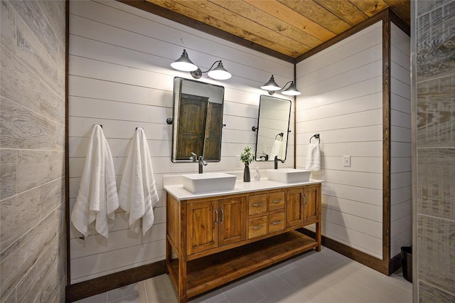 bathroom with tile patterned flooring, vanity, wooden ceiling, and wooden walls