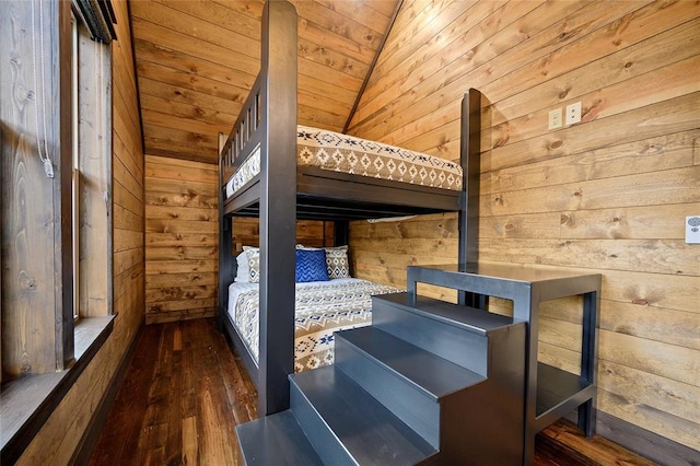 unfurnished bedroom with wood walls, dark wood-type flooring, lofted ceiling, and wood ceiling