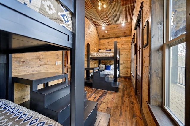 bedroom with dark hardwood / wood-style floors, wooden walls, wooden ceiling, and lofted ceiling