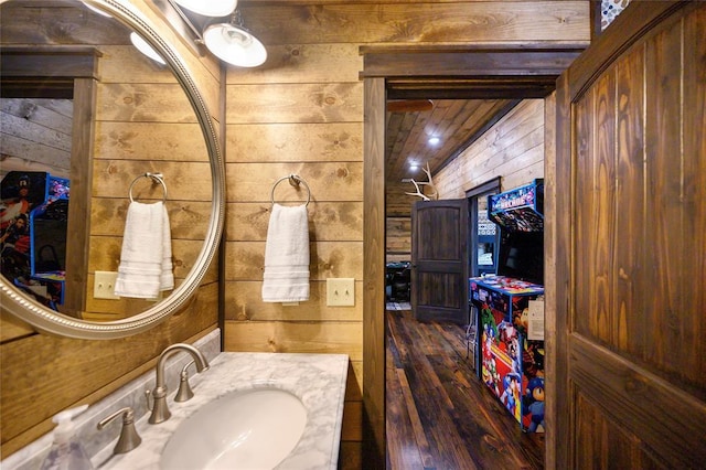 bathroom with vanity and wood walls