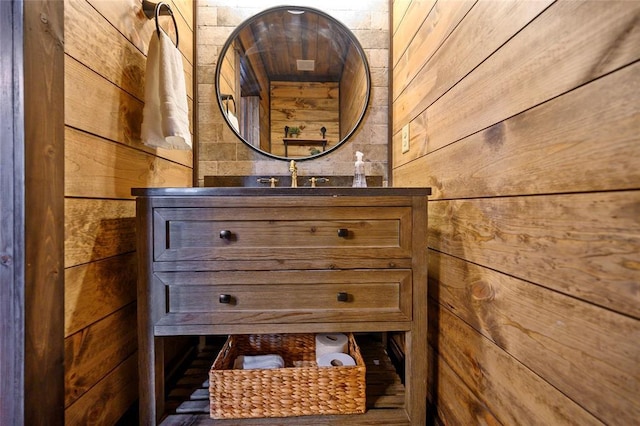 interior space featuring vanity and wood walls