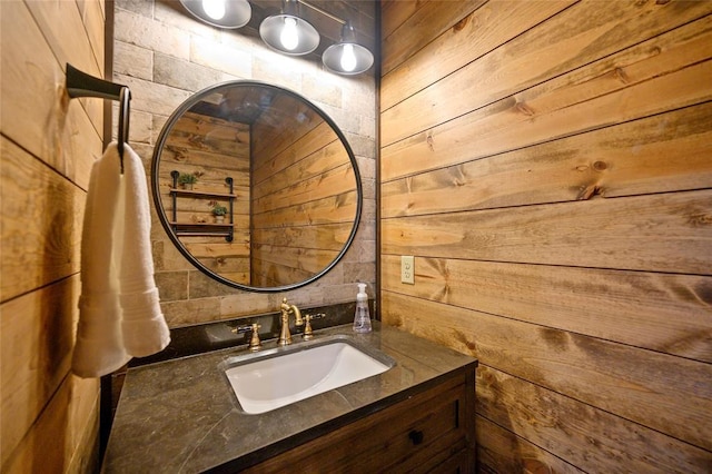 bathroom with vanity and wood walls