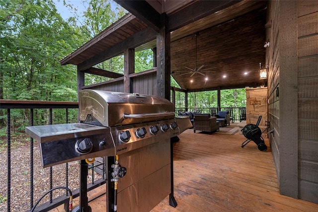 wooden deck with an outdoor hangout area and ceiling fan