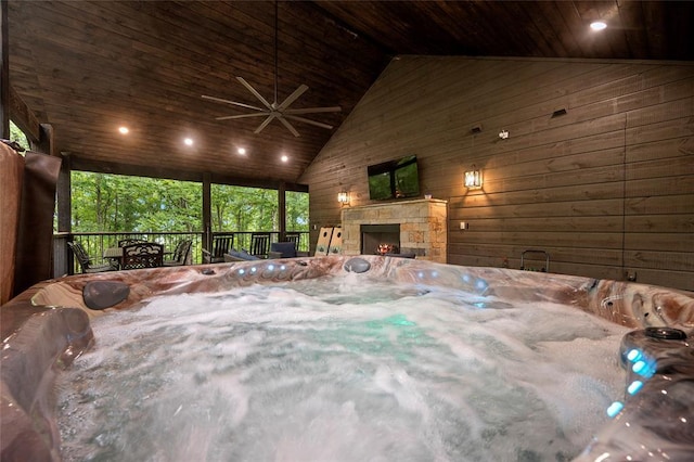 exterior space with an outdoor stone fireplace, high vaulted ceiling, wooden walls, and wood ceiling