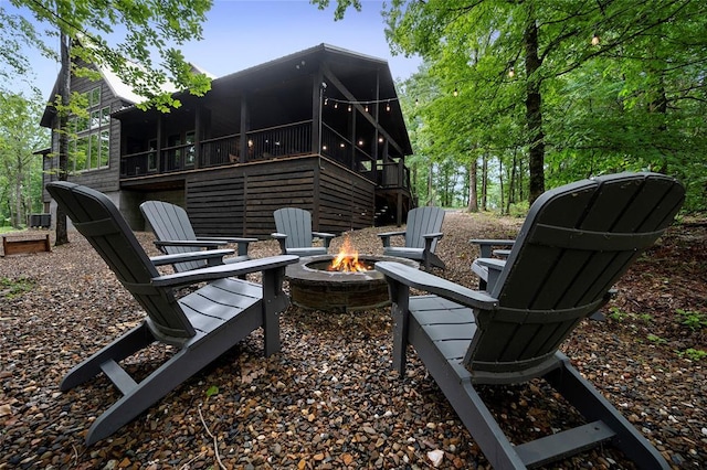 view of patio with a fire pit and a sunroom