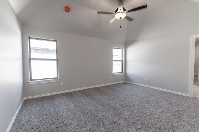 carpeted empty room with ceiling fan and vaulted ceiling