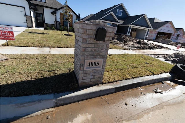 view of front of property with a front yard and a garage