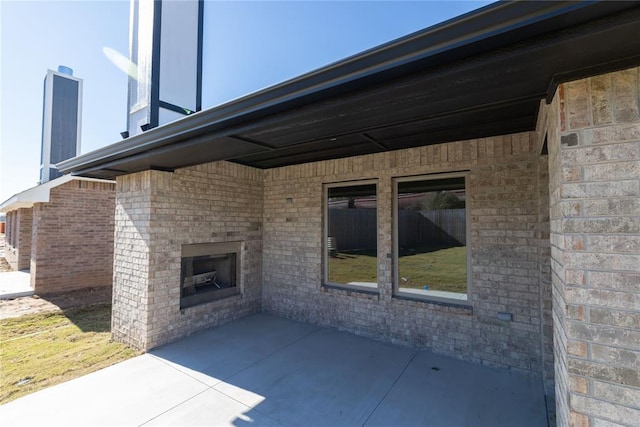 view of patio with an outdoor brick fireplace