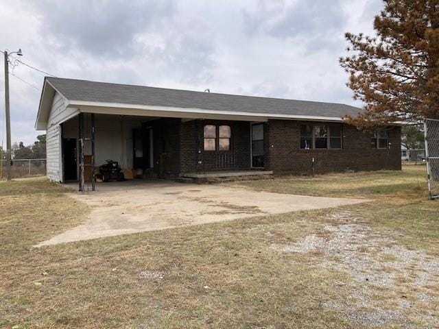 ranch-style home featuring a carport