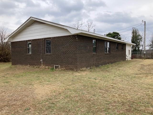 view of side of home featuring a lawn