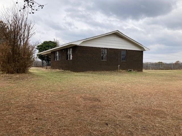 view of side of property with a yard