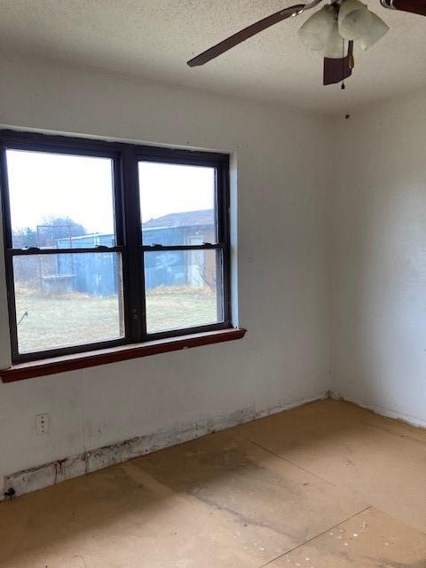 unfurnished room featuring a textured ceiling