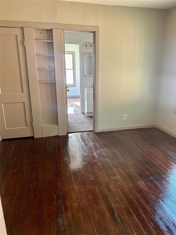 empty room with dark hardwood / wood-style floors