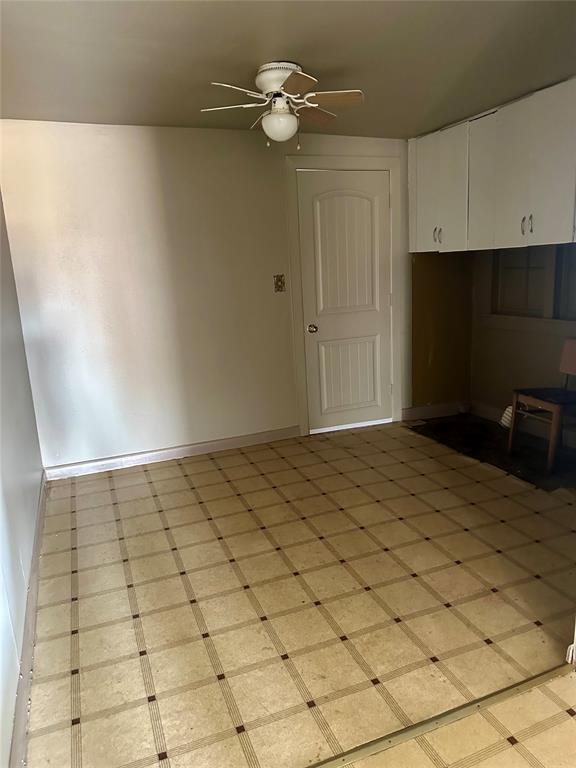 interior space featuring white cabinetry and ceiling fan