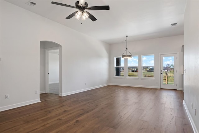 empty room featuring ceiling fan and dark wood-type flooring