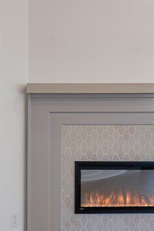 interior details with a tile fireplace