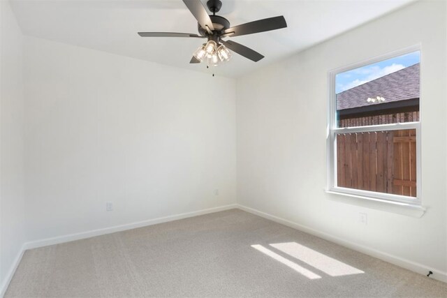 spare room featuring carpet and ceiling fan