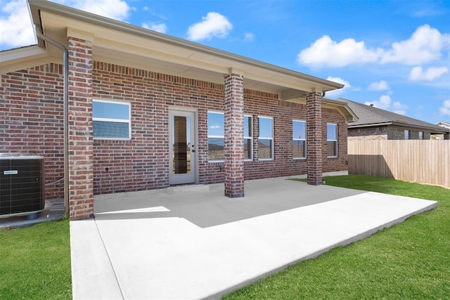 back of property with cooling unit and a patio area