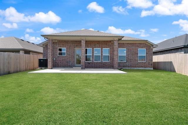 rear view of house with a yard, a patio, and central air condition unit