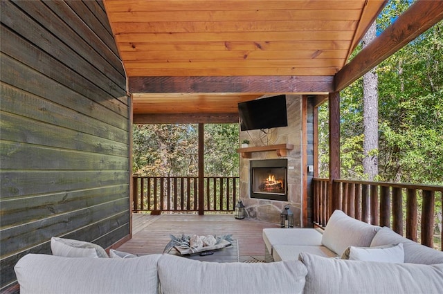 deck featuring an outdoor living space with a fireplace